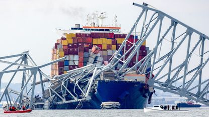 A cargo ship covered in the remnants of a bridge in Baltimore