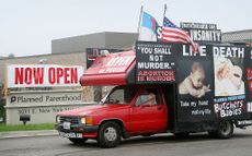 A truck covered in anti-abortion messaging drives past a Planned Parenthood location in Illinois.