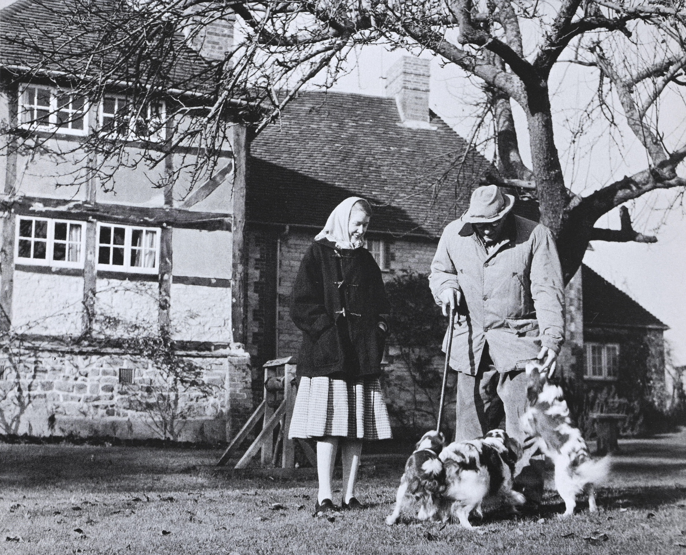 Paul Maze and his wife stand in front of their west sussex home, surrounded by dogs