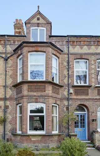 Victorian house with windowed front door, bay windows and brickwork