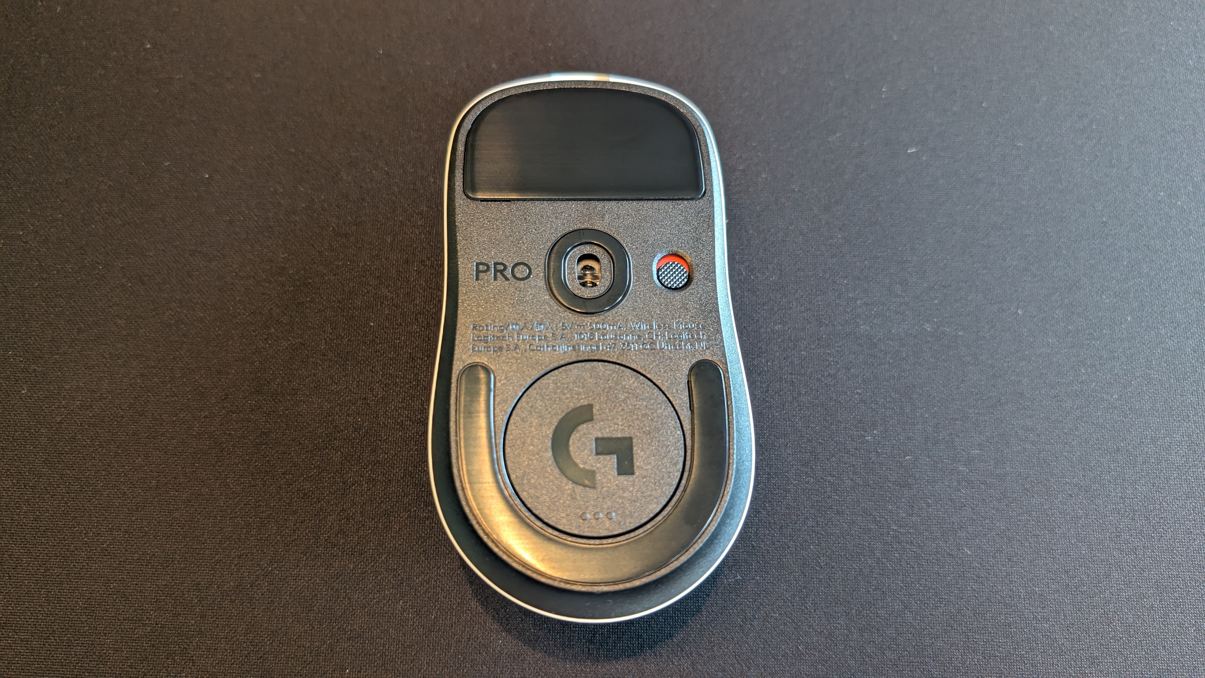 Underside of the Logitech G Pro X2 Superstrike pictured on a black mouse mat.