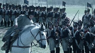 Napoleon VFX; a man rides a horse down a line of soldiers