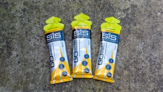 A trio of SIS Go Isotonic Energy Gels on the floor
