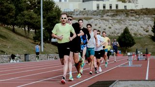 Group of runners training on a running track