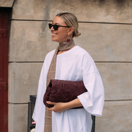 woman wearing a T-shirt and tan scarf 