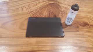 black chromebook on wooden desk