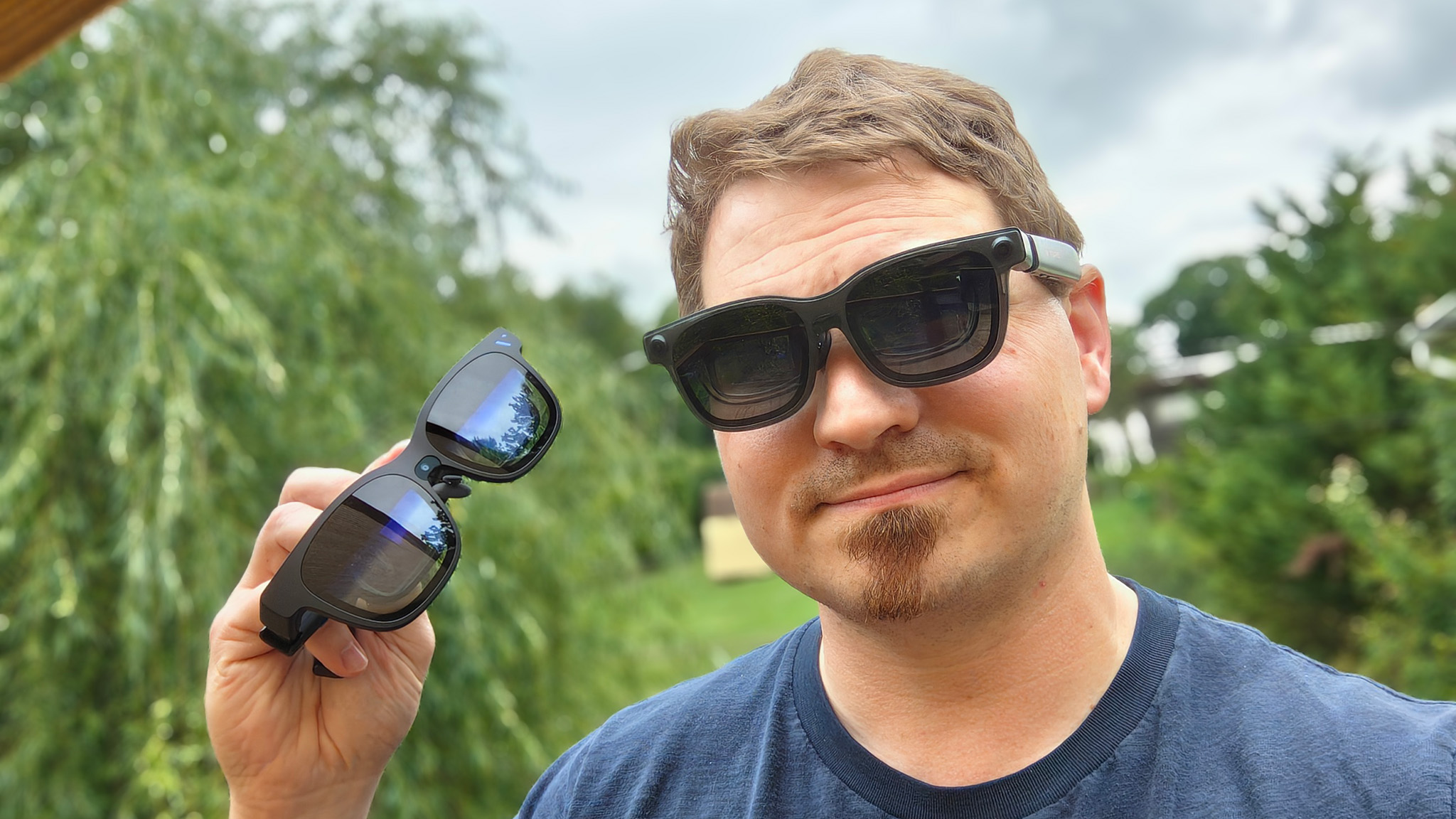 Wearing a Viture Luma Pro smart glasses, holding Viture Beast