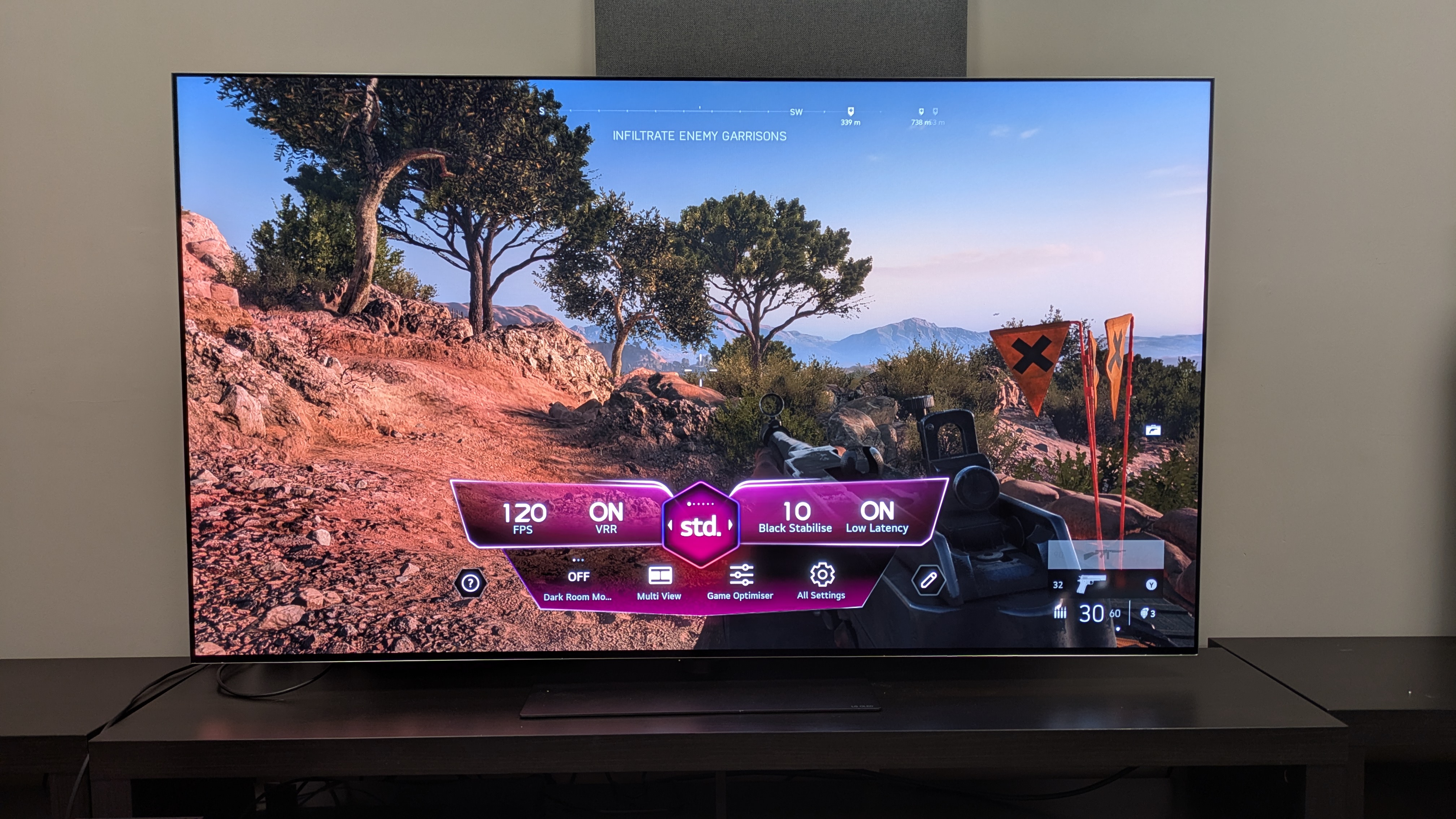 LG G6 OLED TV showing a still of Battlefield V on Xbox Series X with game optimizer menu on bottom of screen, showing 120Hz refresh rate