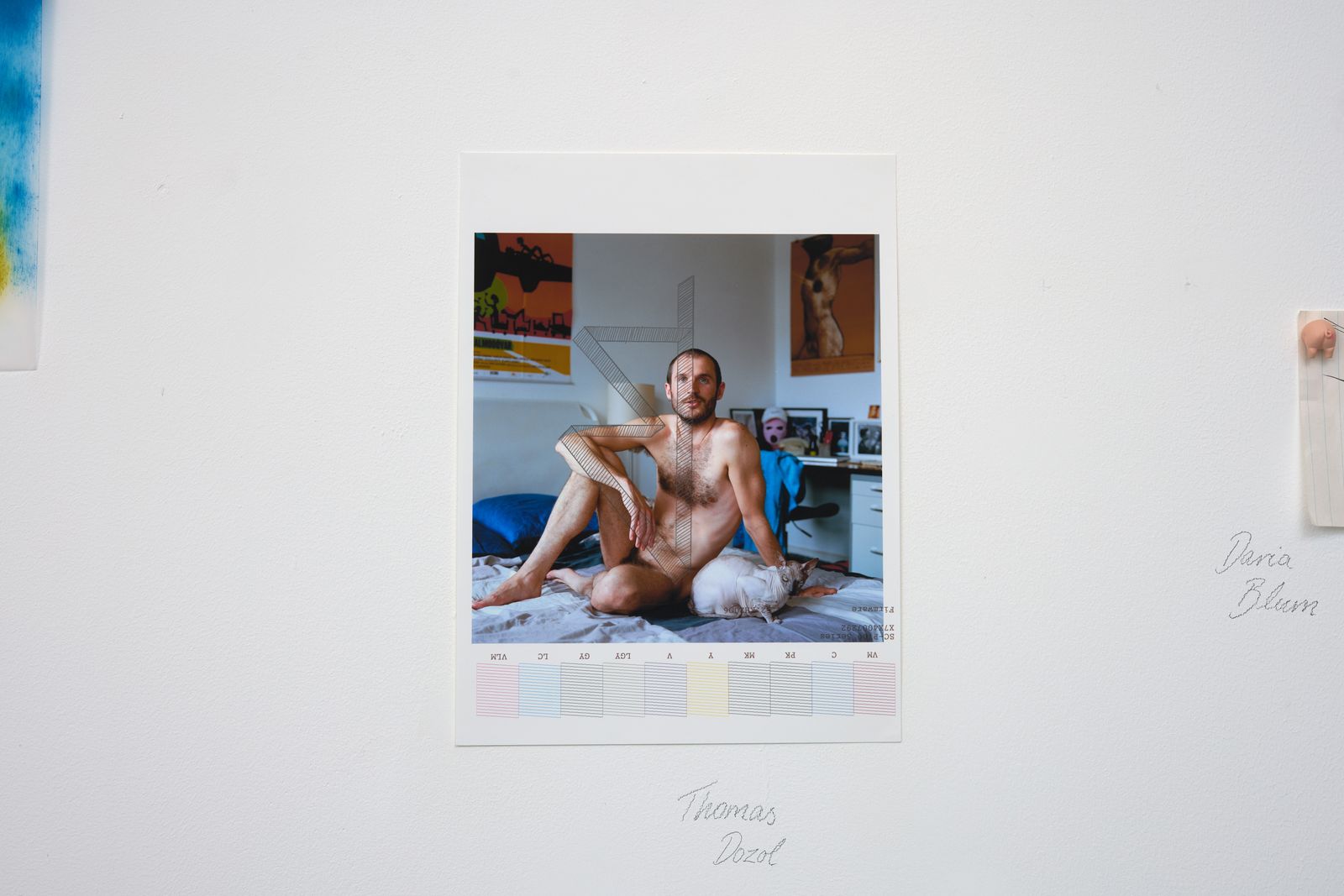 photo of nude man pinned to wall