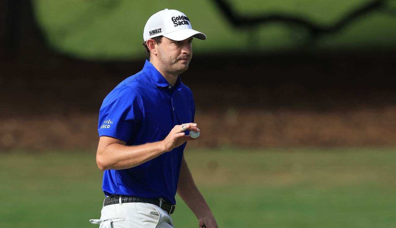 Cantlay waves to the crowd whilst holding a golf ball