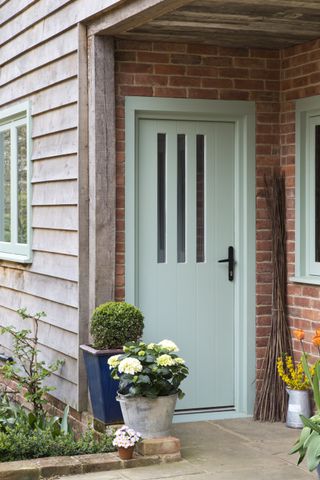painted front door in pale green and glazed panels