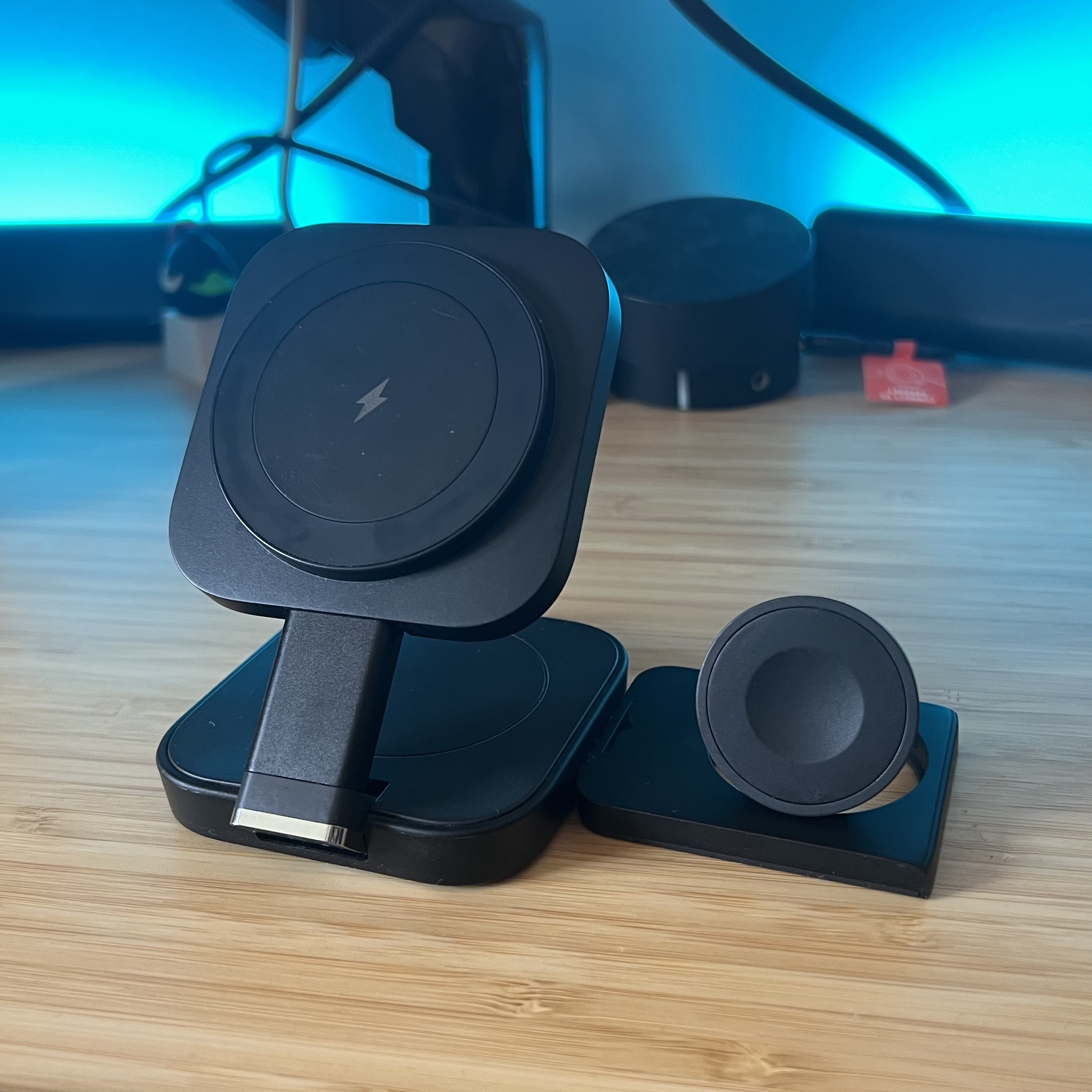 Lisen 3-in-1 MagSafe charger on a wooden desk with blue backlighting