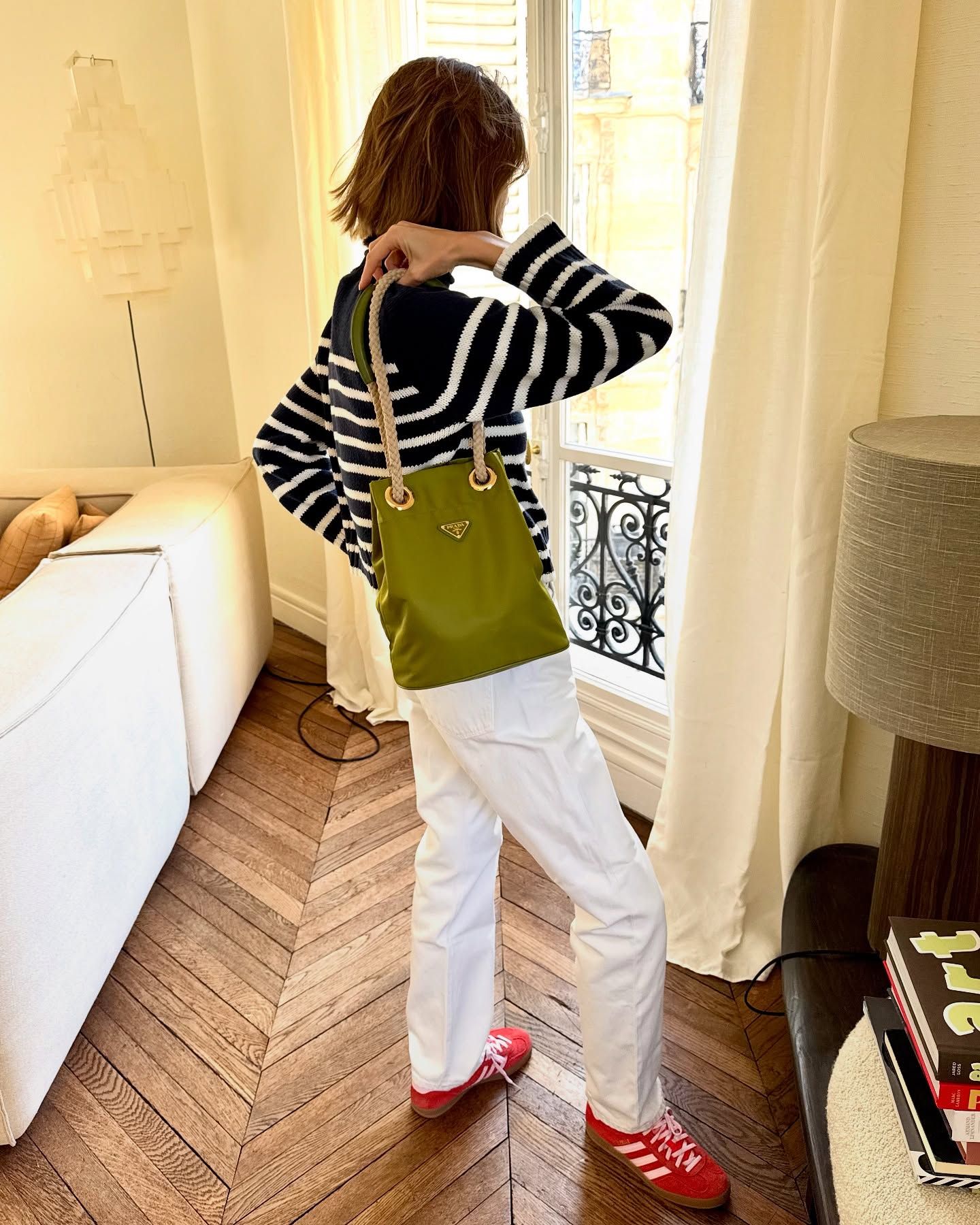 Woman in white jeans and red suede sneakers