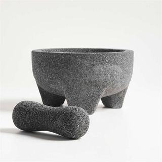 A large stone molcajete against a white background