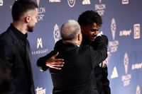 Spain and Barcelona forward Lamine Yamal is hugged by president of FC Barcelona Joan Laporta