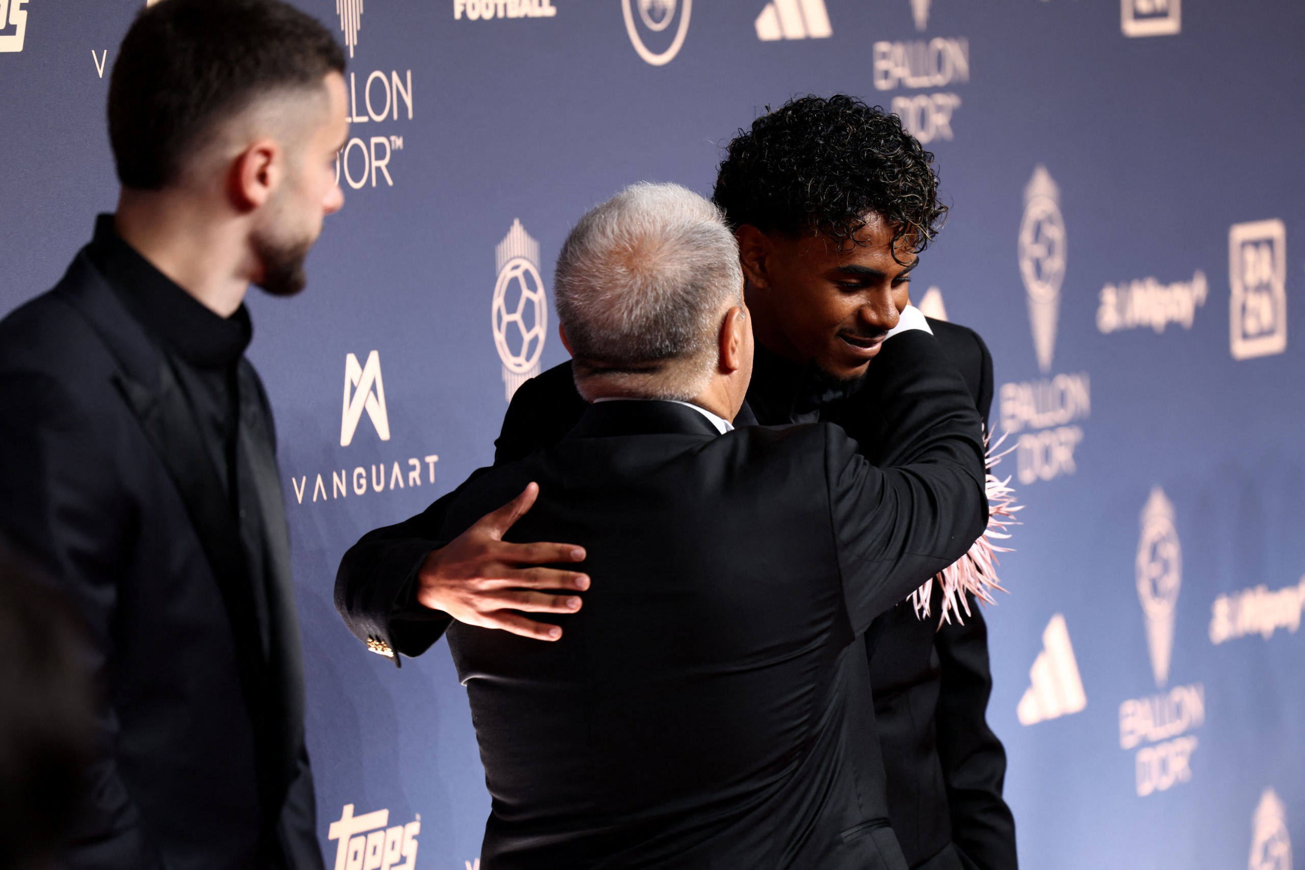 Spain and Barcelona forward Lamine Yamal is hugged by president of FC Barcelona Joan Laporta