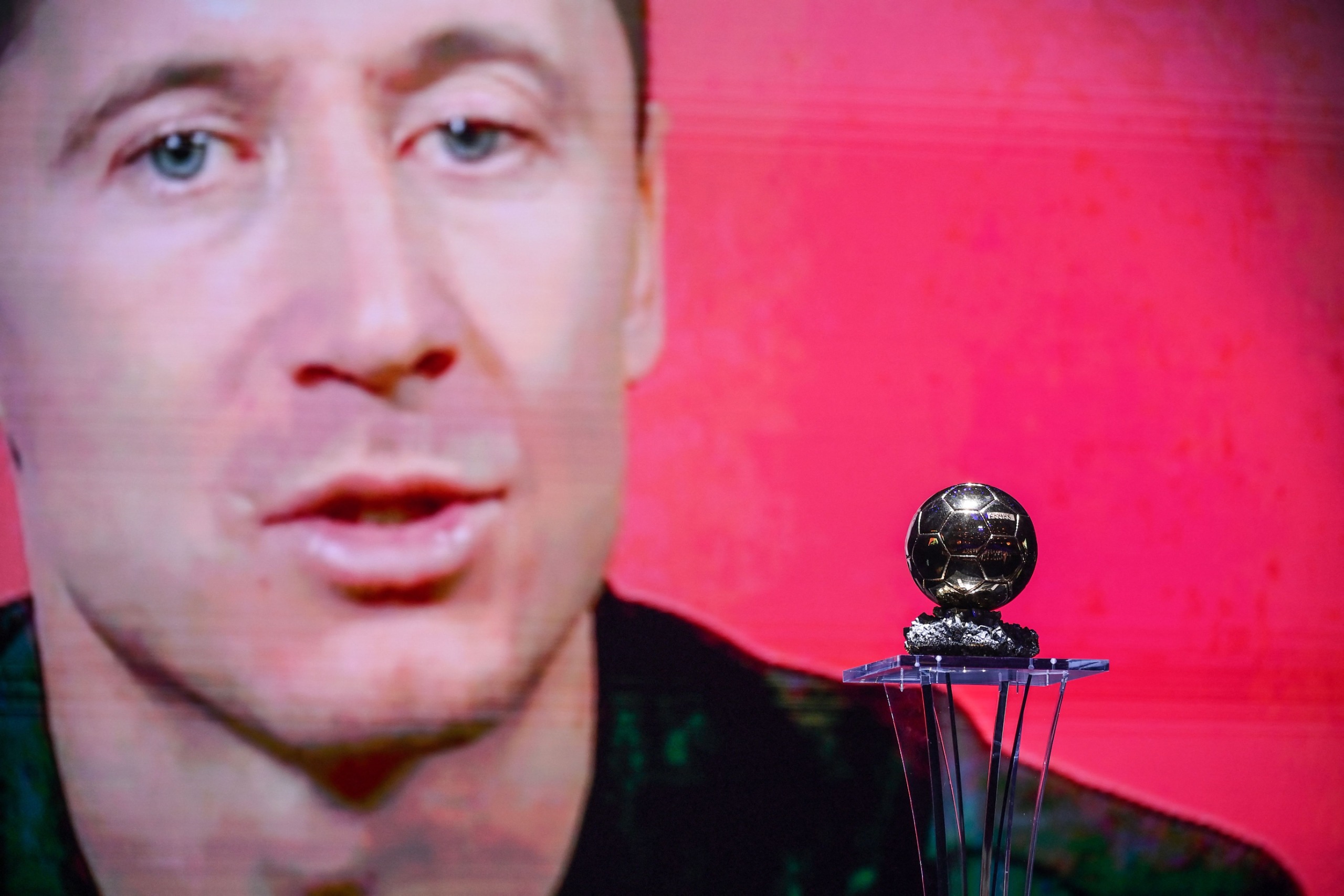 Striker of the Year recipient Bayern Munich's Polish forward Robert Lewandowski is seen on a screen during the 2021 Ballon d'Or France Football award ceremony at the Theatre du Chatelet in Paris on November 29, 2021