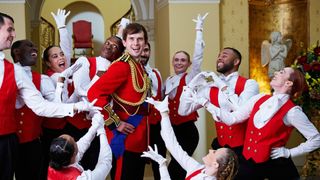 Kieran Hodgson as Prince Andrew surrounded by dancers posing for Prince Andrew: The Musical