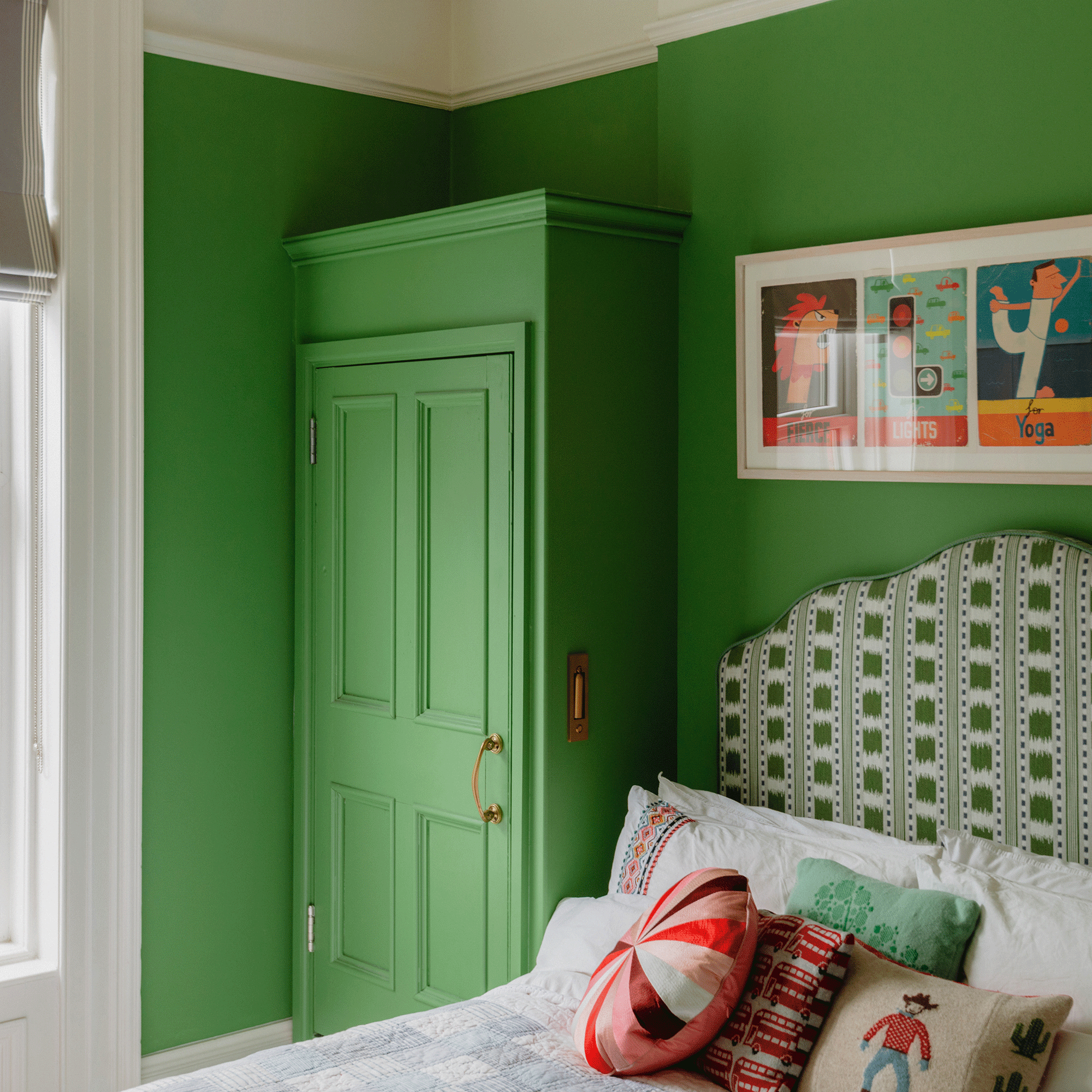 Green bedroom with green headboard and cowboy cushions