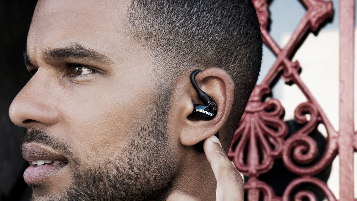 a closeup of the shure apnic 215 2nd gen true wireless earbuds in someone&#039;s ear