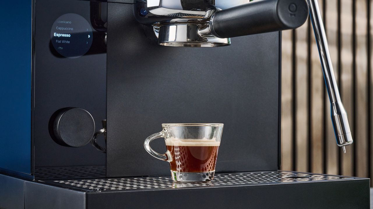 the fellow espresso series 1 photographed against a blue tom's guide background showing espresso, LCD smart screen, steam wand