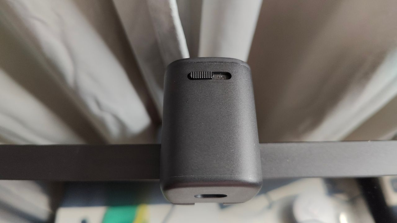 Topdown photo of Anker PowerConf C200 webcam mounted on a monitor showing privacy shutter switch