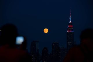 The full Buck Moon of July 2020 rises over the Empire State Building in New York City, United States on July 4, 2020