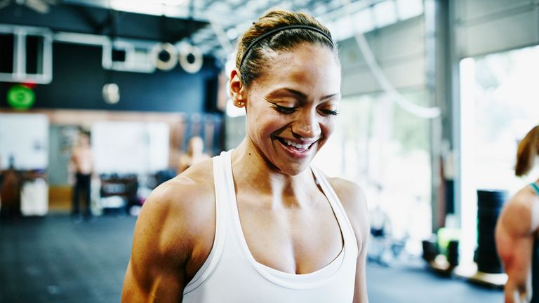 Woman smiling in fitness gear.