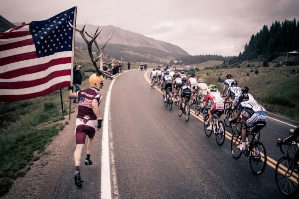 A fan offers encouragement as the group hits the last climb.