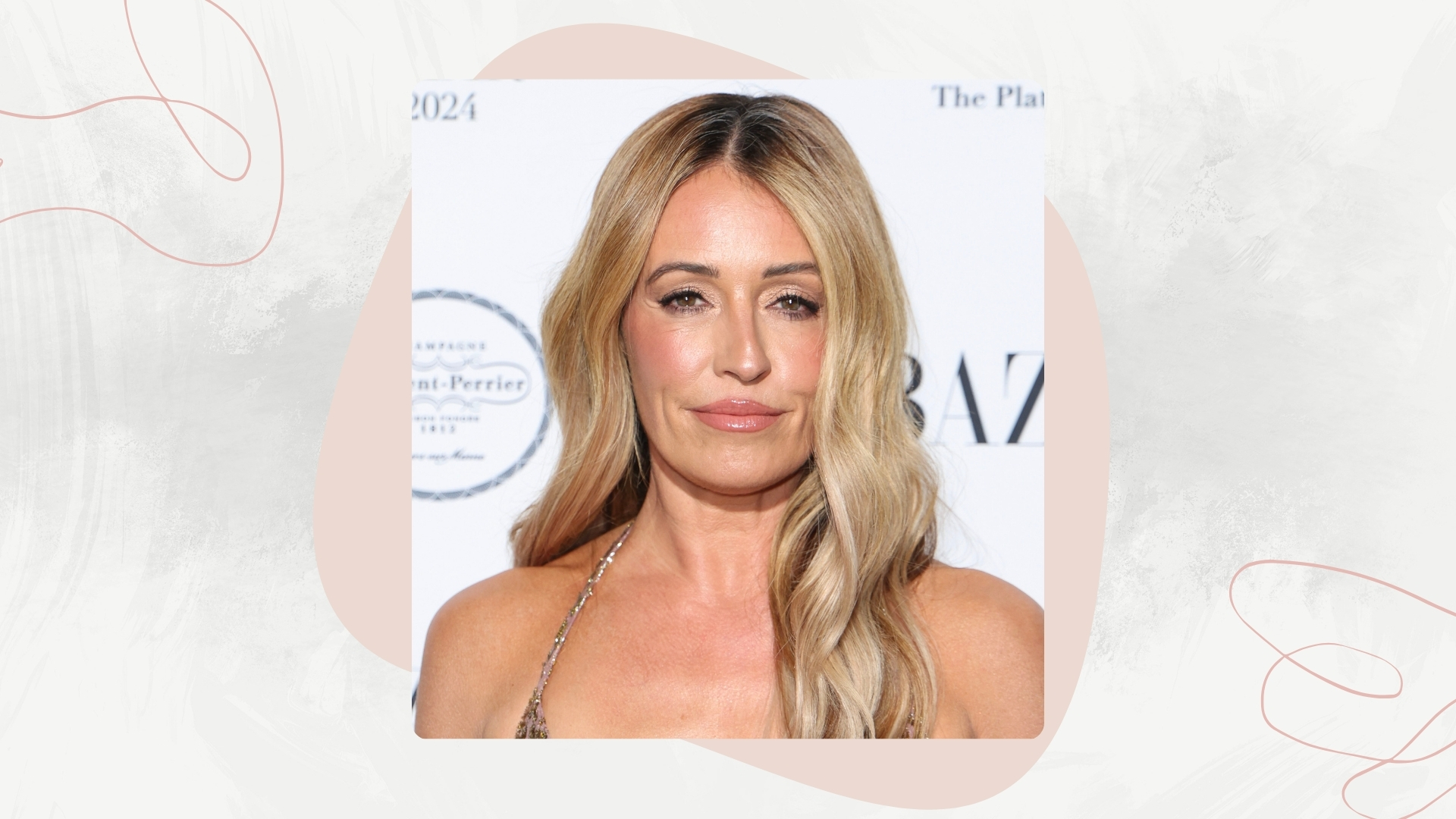 Image of Cat Deeley smiling with curled blonde long hair on a white marble background, pink motifs and swirls