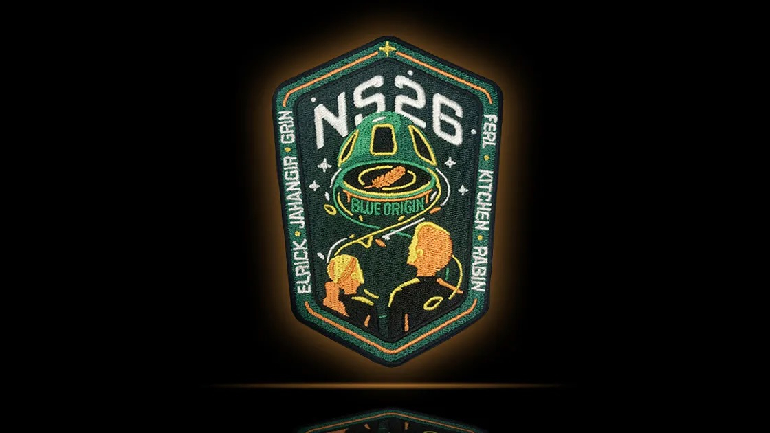 a mission badge showing a cone-shaped spaceship and vague outlines of human heads