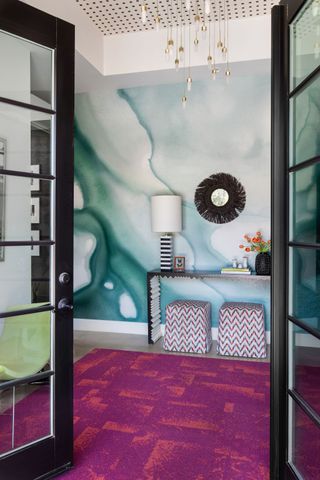 entrance hall with watercolor wallpaper and purple and red rug