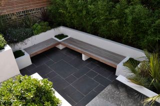 floating bench in small paved space by tom howard garden design