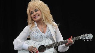 GLASTONBURY, ENGLAND - JUNE 29: Dolly Parton performs on the Pyramid stage during day three of the Glastonbury Festival at Worthy Farm in Pilton on June 29, 2014 in Glastonbury, England. Tickets to the event, which is now in its 44th year, sold out in minutes even before any of the headline acts had been confirmed. The festival, which started in 1970 when several hundred hippies paid &pound;1, now attracts more than 175,000 people. (Photo by Jim Dyson/Getty Images)