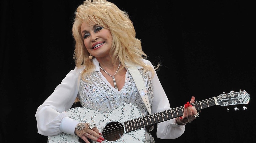 GLASTONBURY, ENGLAND - JUNE 29: Dolly Parton performs on the Pyramid stage during day three of the Glastonbury Festival at Worthy Farm in Pilton on June 29, 2014 in Glastonbury, England. Tickets to the event, which is now in its 44th year, sold out in minutes even before any of the headline acts had been confirmed. The festival, which started in 1970 when several hundred hippies paid &pound;1, now attracts more than 175,000 people. (Photo by Jim Dyson/Getty Images)
