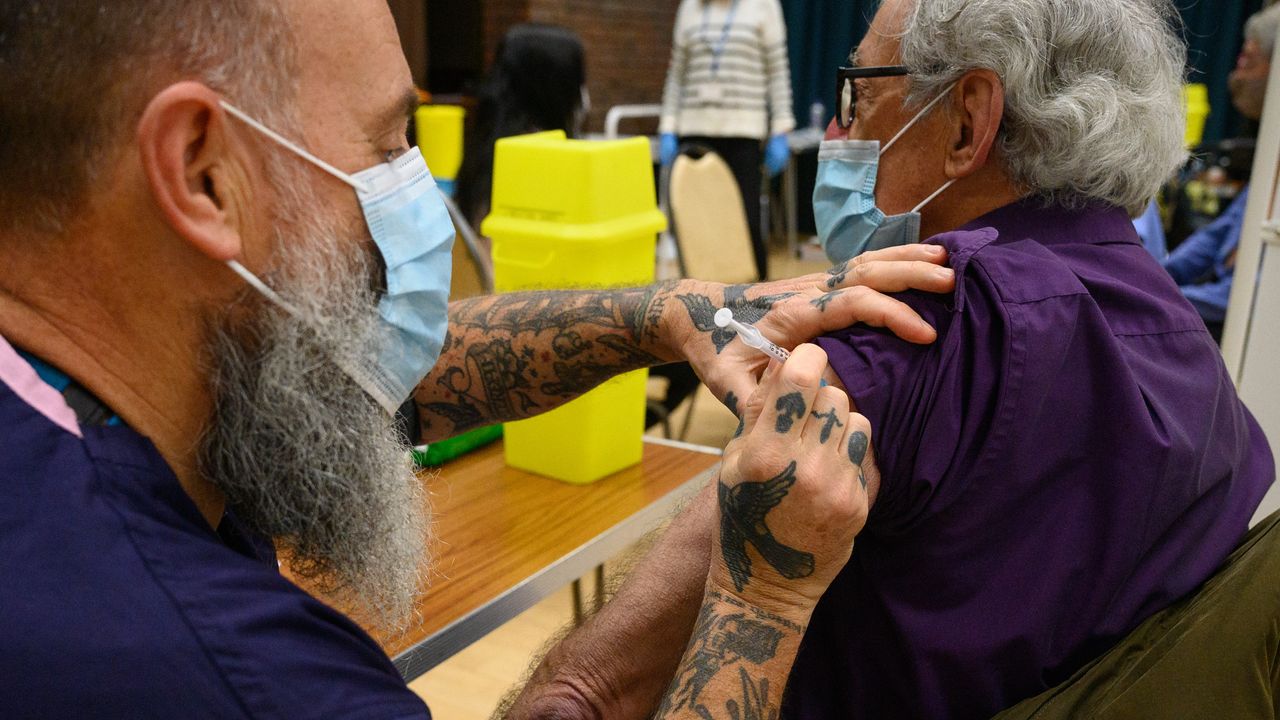 A paramedic gives a Covid-19 vaccination.