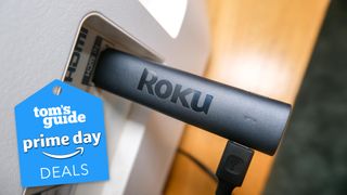 The Roku Streaming Stick 4K plugged into an HDMI port with a Tom's Guide Prime Day Deals graphic