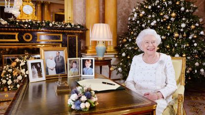 Queen Elizabeth II sits at a desk in the 1844 Room at Buckingham Palace, after recording her Christmas Day broadcast in 2017