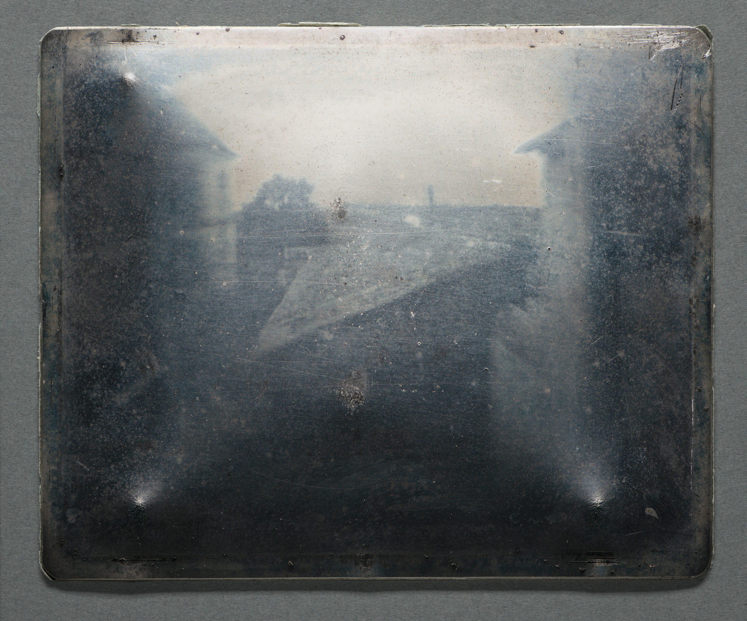 View from the Window at Le Gras], 1827. Heliograph on pewter, 16.7 x 20.3 x .15 cm. Gernsheim Collection