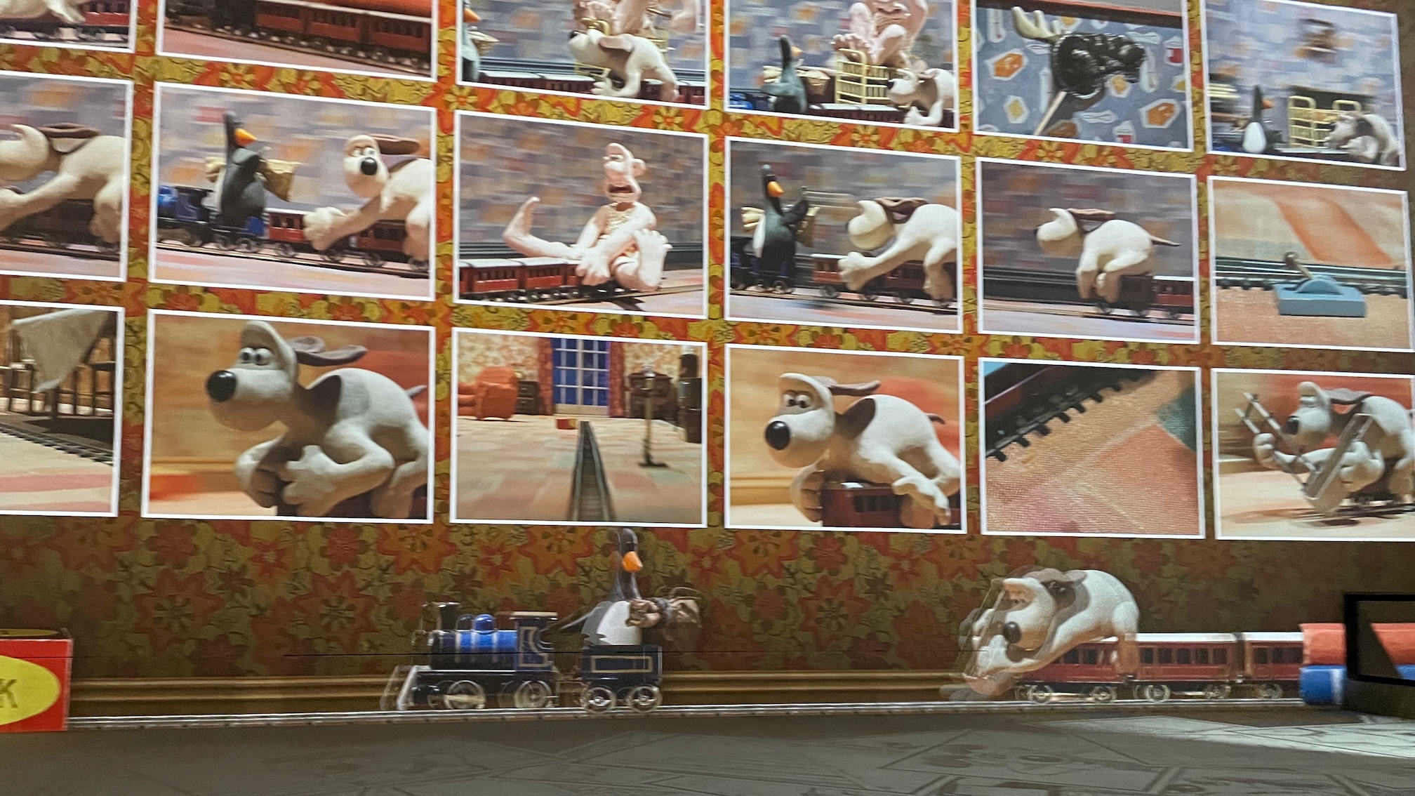 The model train chase scene from The Wrong Trousers projected onto the wall in Lightroom, Kings Cross, as part of the exhibition Larger Than Life: Wallace &amp;amp; Gromit, Shaun And More &amp;ndash; The Aardman Story.