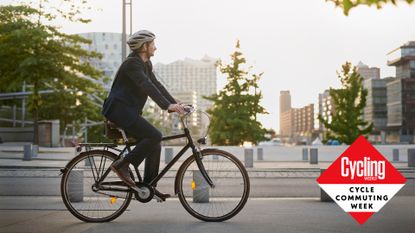 Image shows a man cycle commuting to work to reap the benefits. 