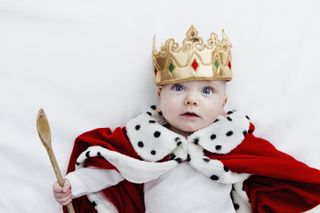 baby wearing royal outfit with crown