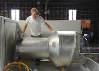 A technician at Genesis Engineering Solutions readies a prototype of its single-person spacecraft for pressure testing.