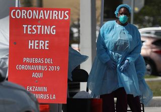A member of the health care staff from the Community Health of South Florida, Inc. prepares to test people for the novel coronavirus on March 18, 2020 in Miami, Florida. 
