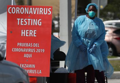 A member of the health care staff from the Community Health of South Florida, Inc. prepares to test people for the novel coronavirus on March 18, 2020 in Miami, Florida.