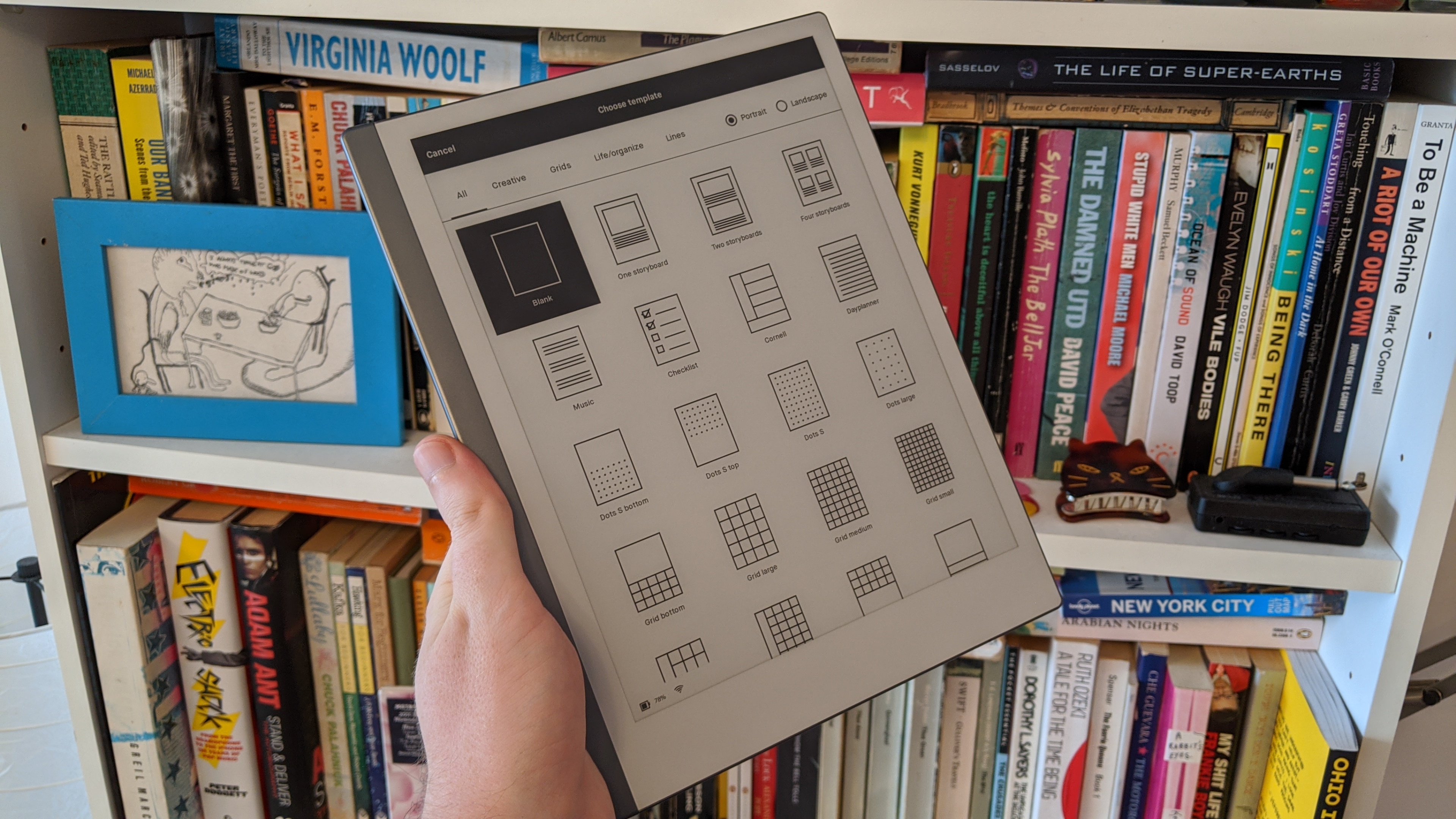 A ReMarkable 2 tablet in someone's hand, displaying a template list