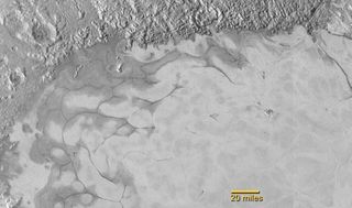 This photo of Pluto shows the northern region of Sputnik Planum, where flows of exotic ices have created swirl-shaped patterns much like glaciers on Earth, scientists say. NASA unveiled this image on July 24, 2015.