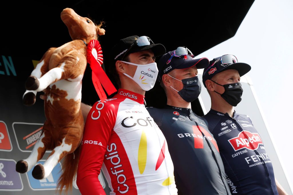 WAREGEM BELGIUM MARCH 31 Podium Christophe Laporte of France and Team Cofidis Dylan Van Baarle of Netherlands and Team INEOS Grenadiers Tim Merlier of Belgium and Team AlpecinFenix Celebration during the 75th Dwars Door Vlaanderen 2021 Mens Elite a 1841km race from Roeselare to Waregem Mask Covid safety measures Horse Mascot DDV DDV21 FlandersClassic A travers la Flandre on March 31 2021 in Waregem Belgium Photo by Bas CzerwinskiGetty Images