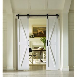 White metal sliding bar door looking onto dining room with frame