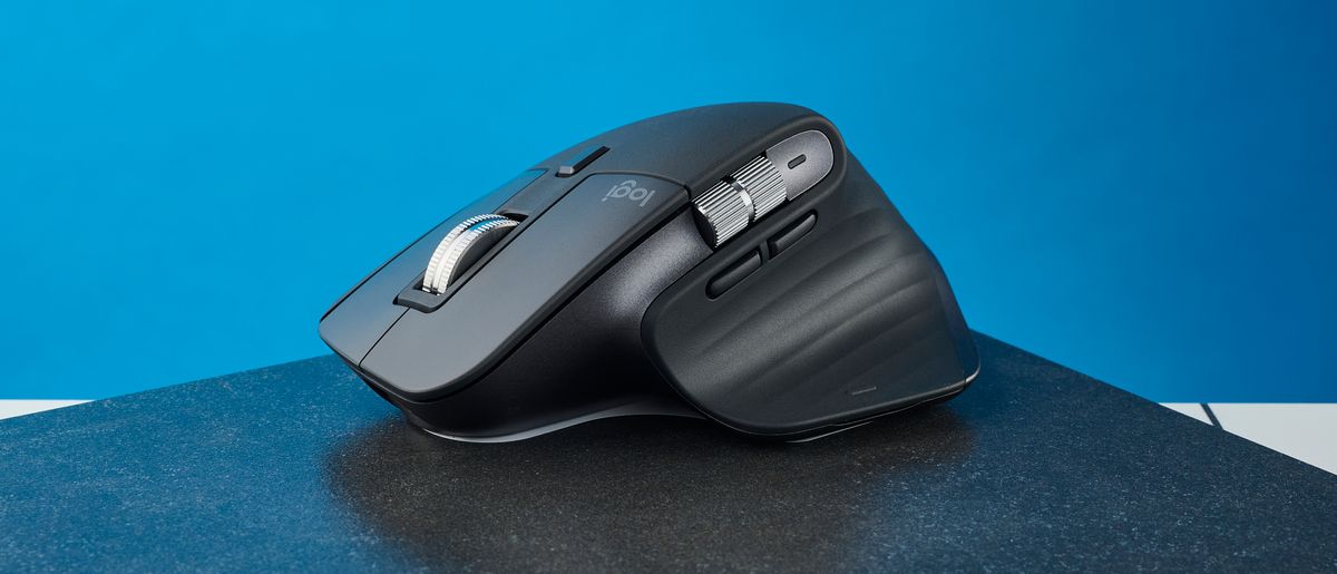 A photo of the Logitech MX Master 3S on a black slate against a blue background.